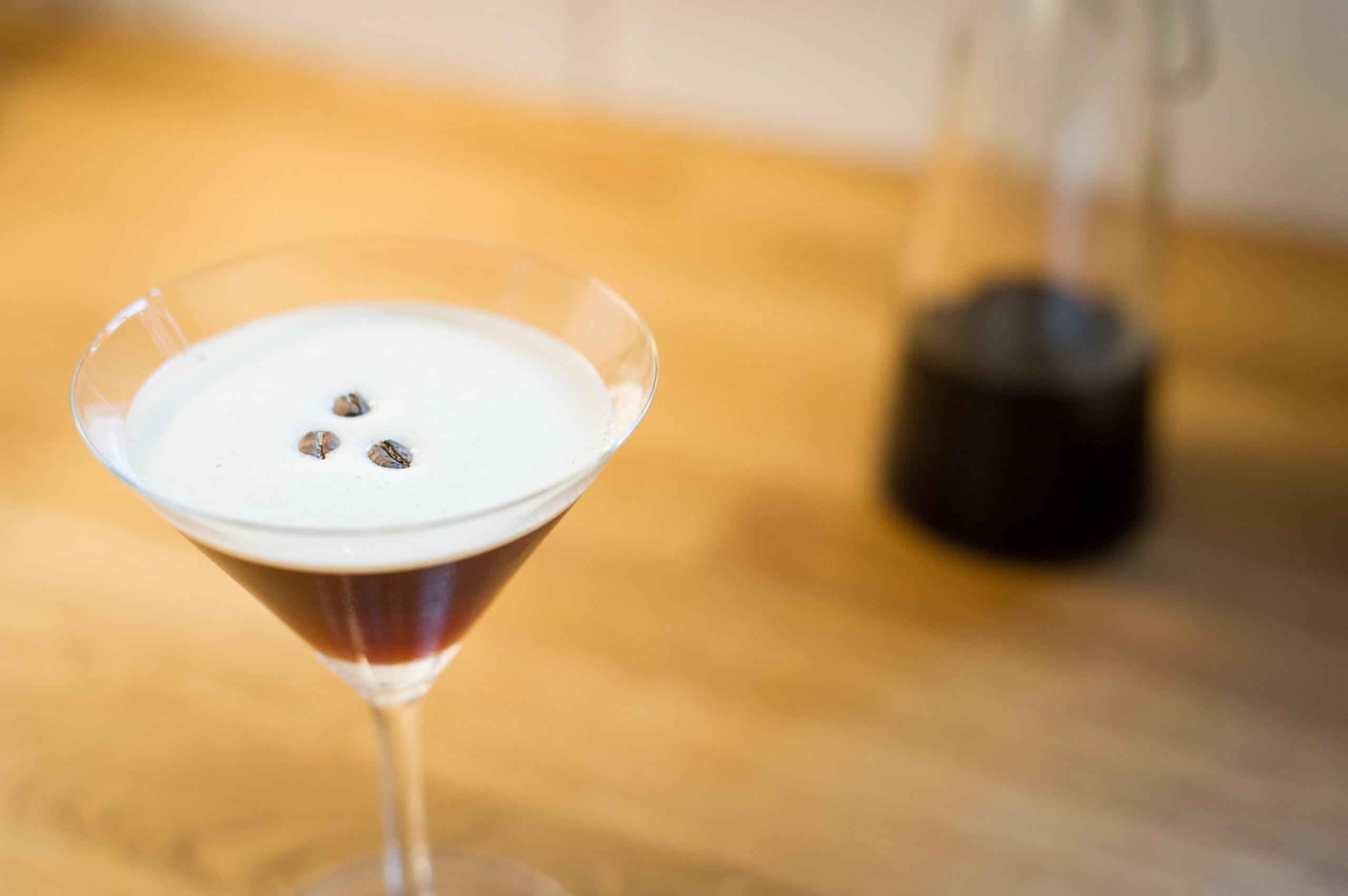 looking down on an espresso martini with 3 coffee beans