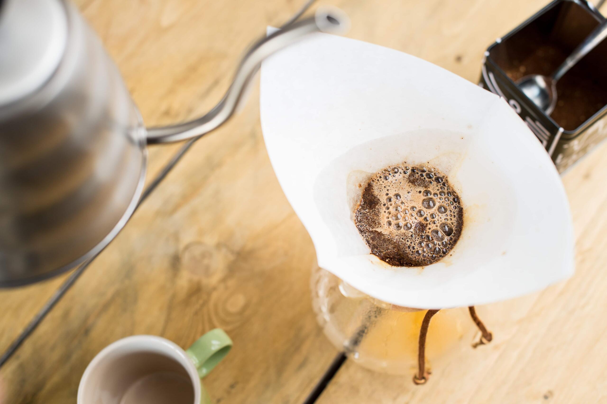 A Chemex coffee maker with coffee blooming