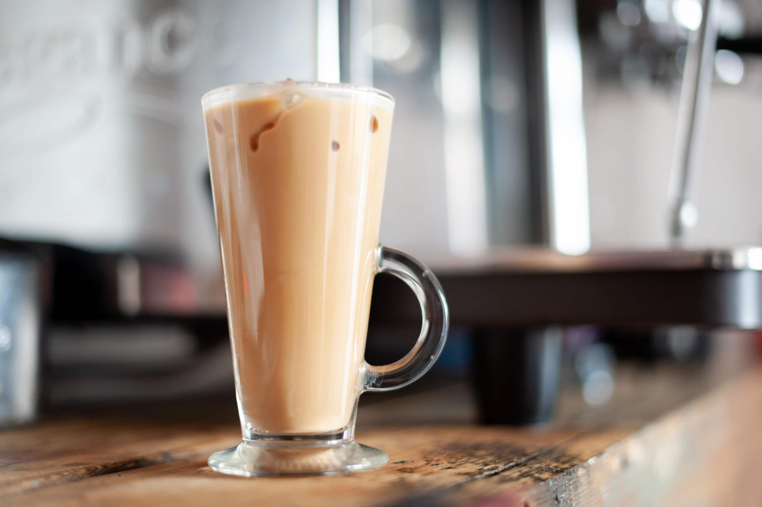 A tall glass filled with iced coffee