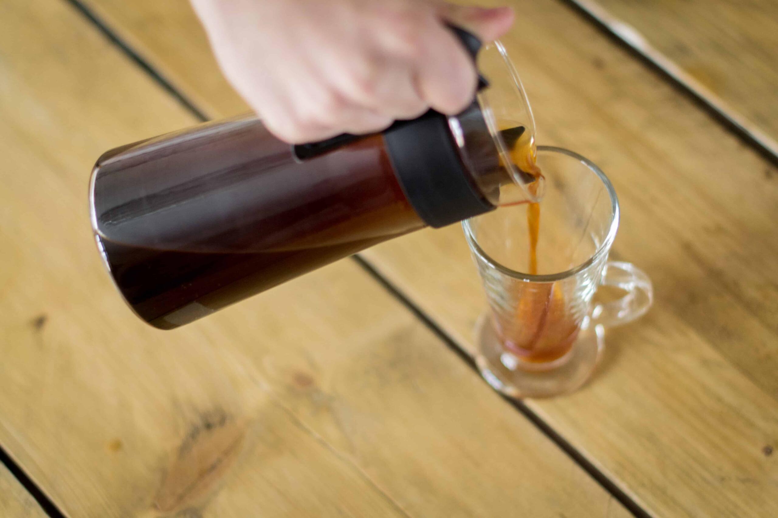 pouring cold brew coffee into a glass