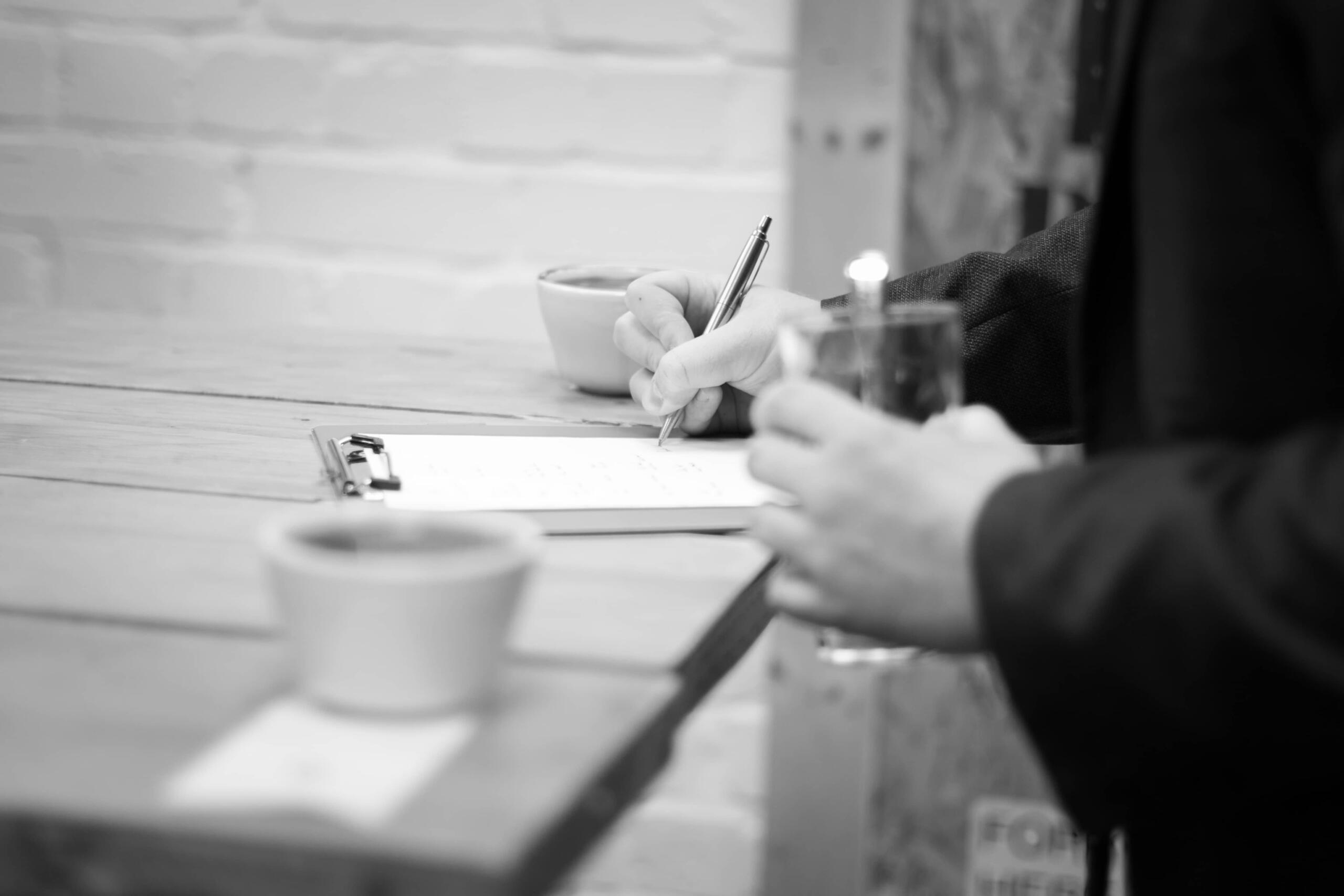 writing notes at coffee cupping - a close up of the pen and paper