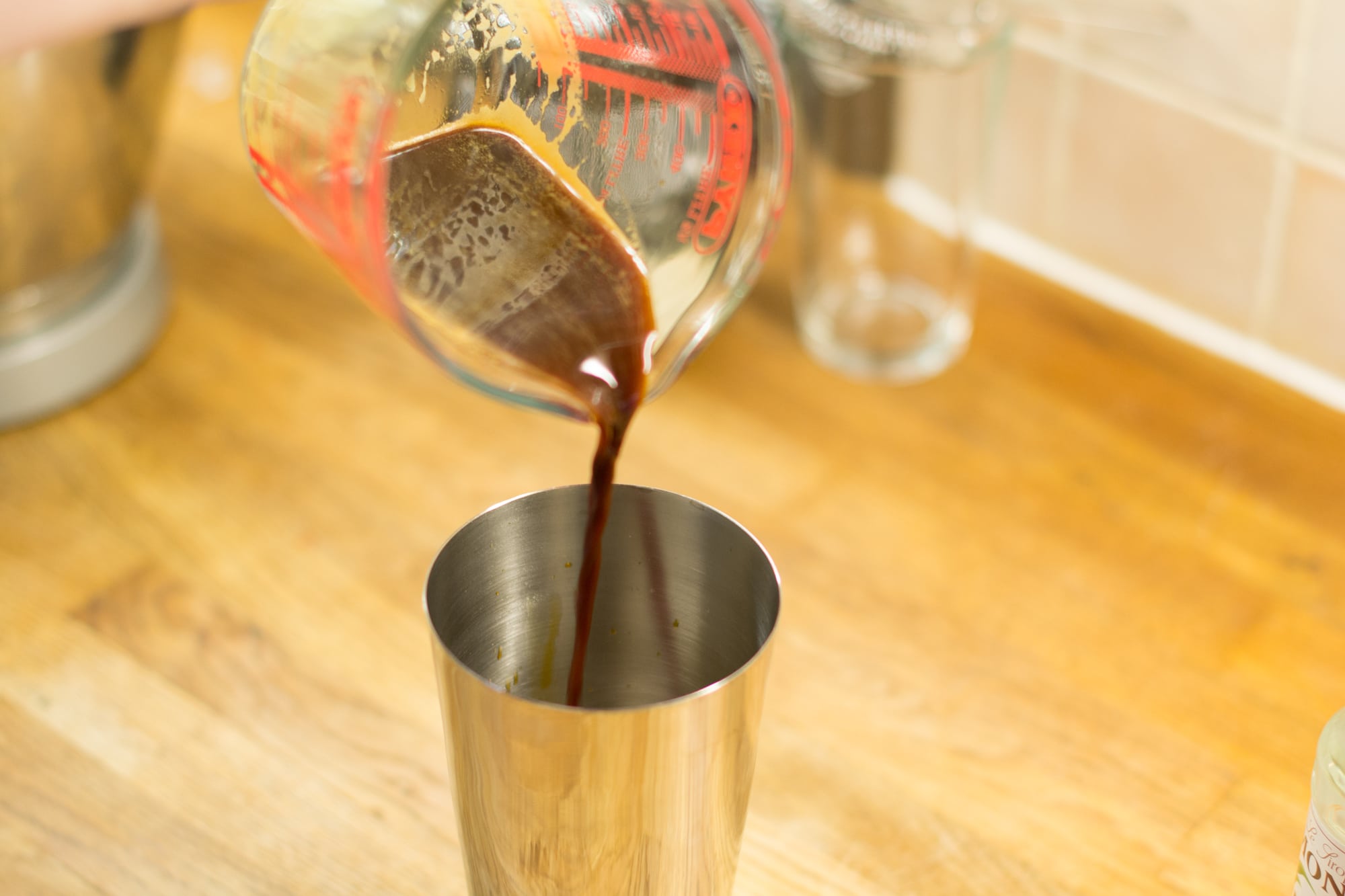 Pouring espresso coffee into cocktail shaker