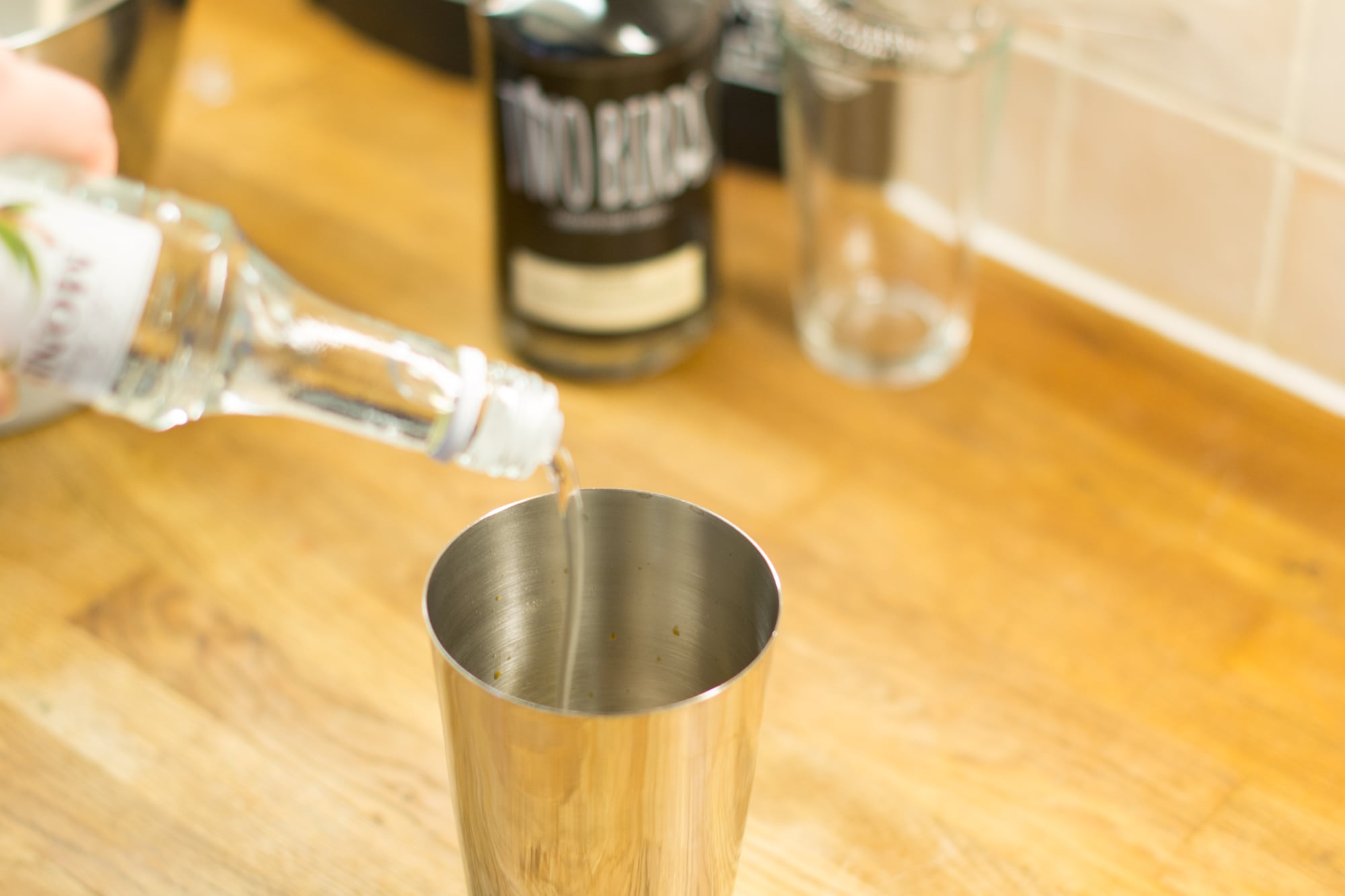 Pouring sugar syrup into cocktail shaker