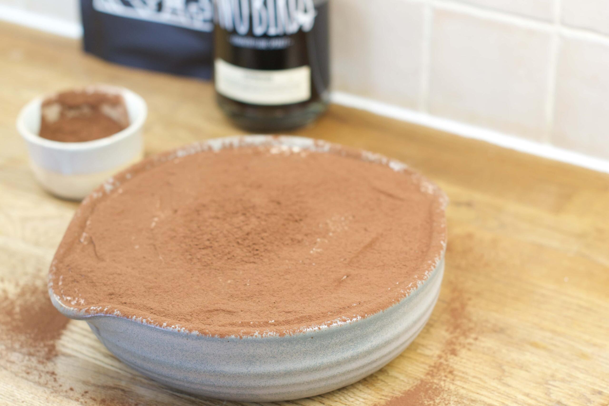 cover the top layer with a coating of cocoa powder and serve
