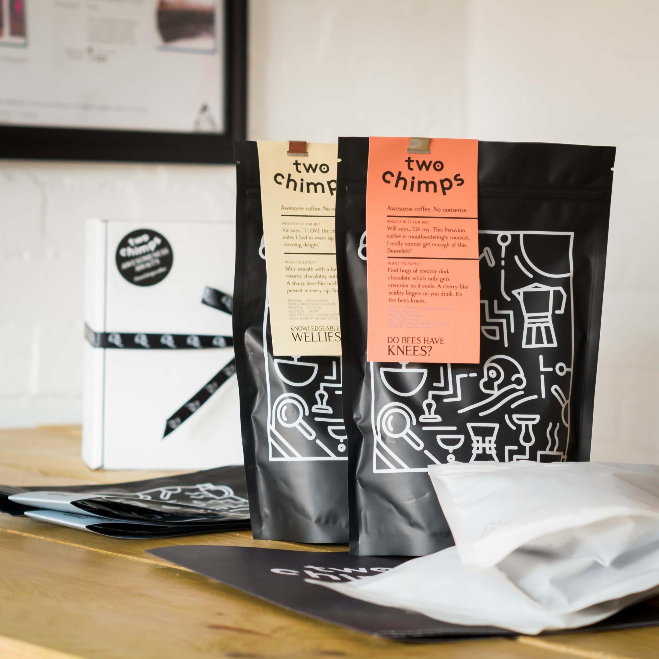 coffee roasting gift set with bags of gree and roasted coffee on a table