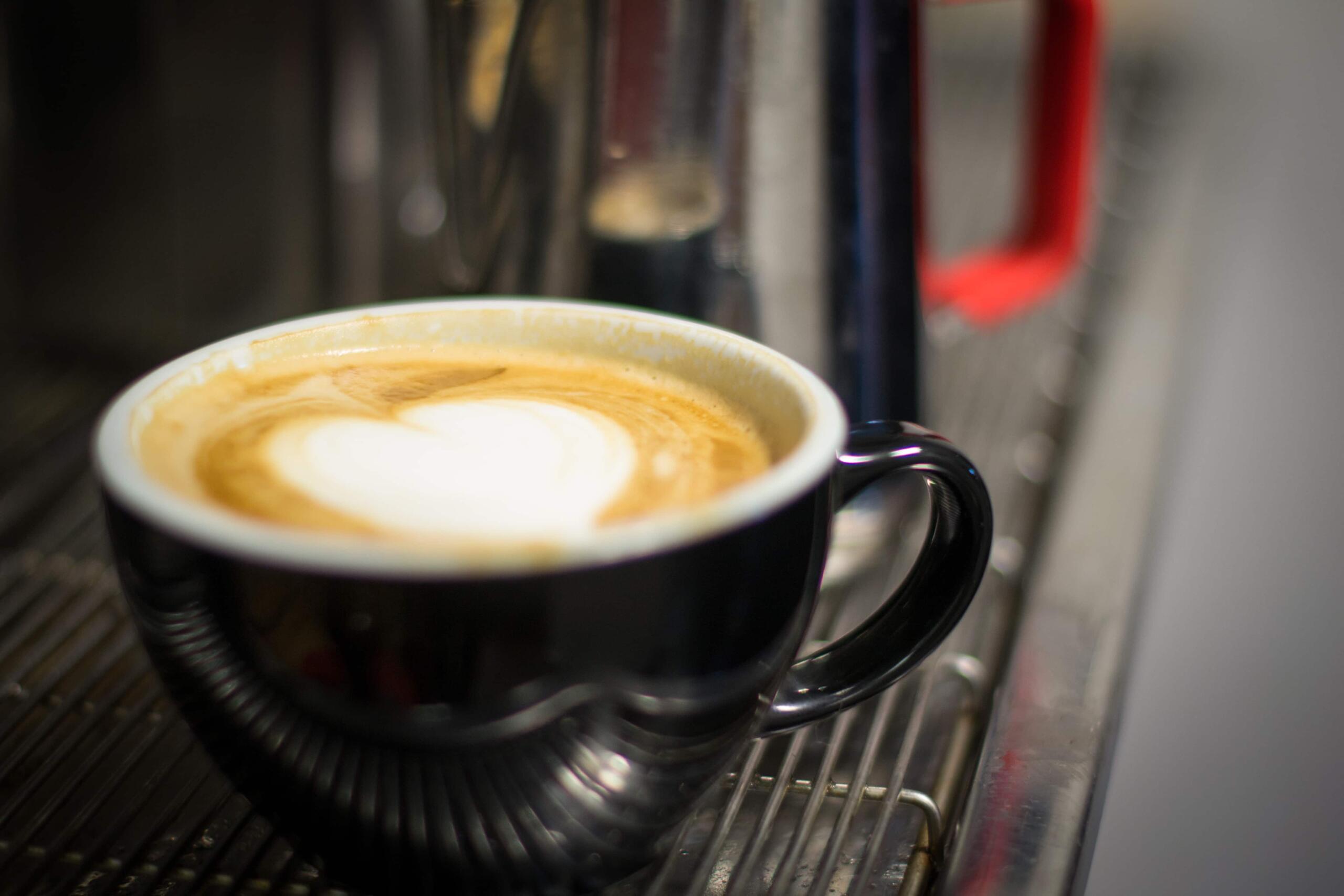 Latte sitting on espresso machine