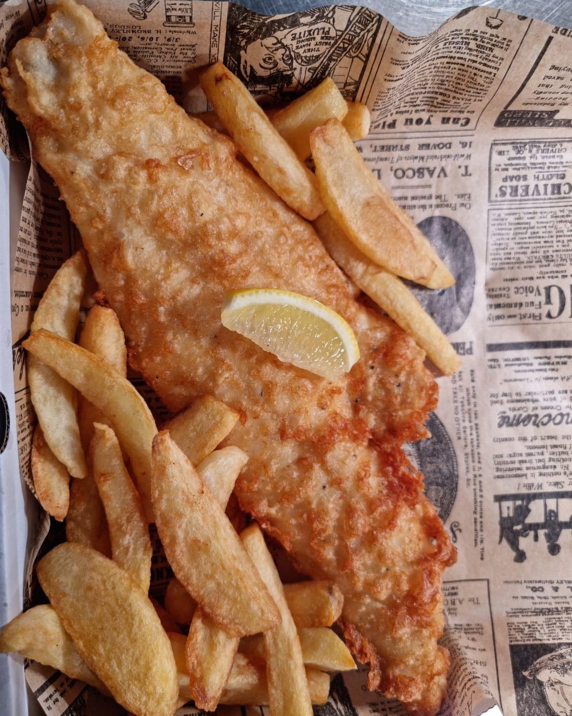 haddock and triple cooked chips on newspaper