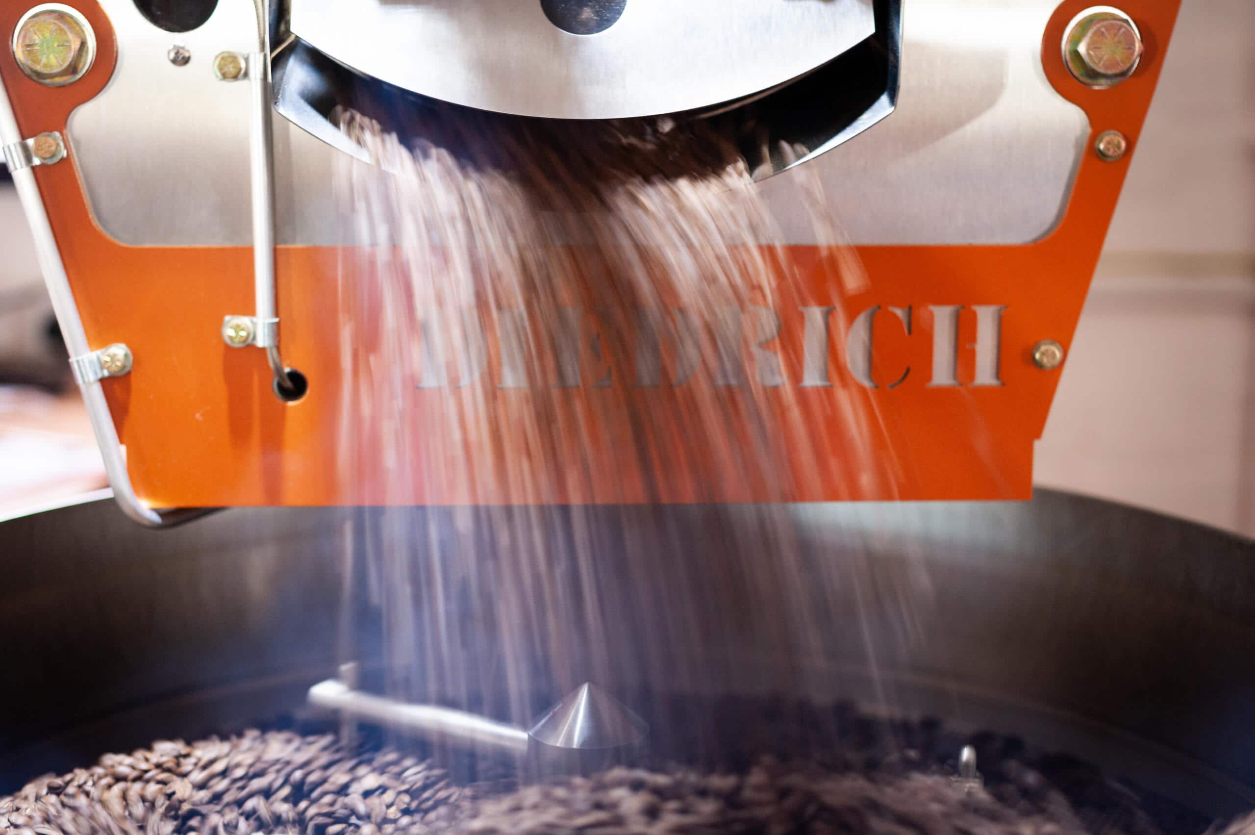 Coffee beans tipping out of roaster 