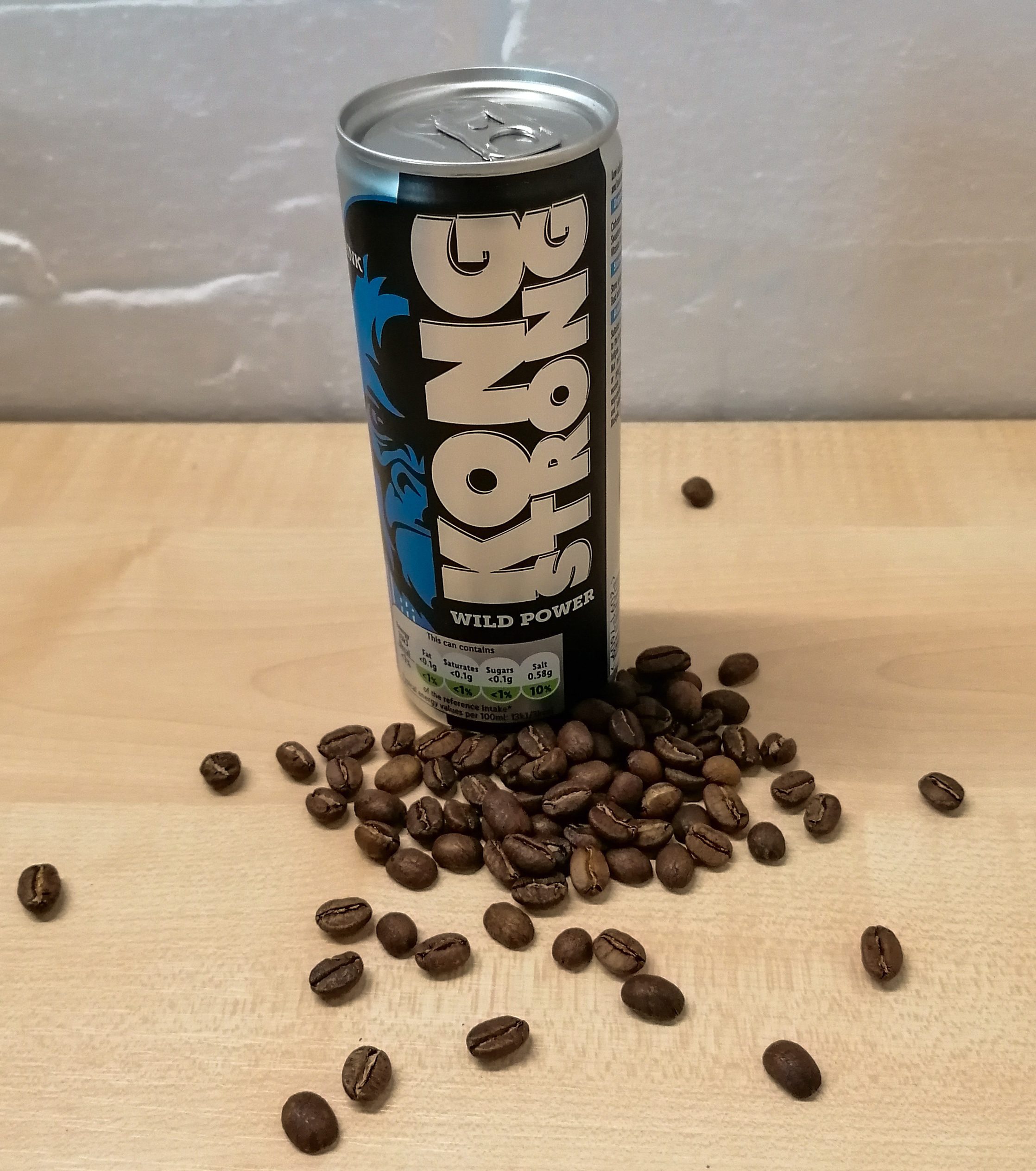 Can of energy drink besides coffee beans 