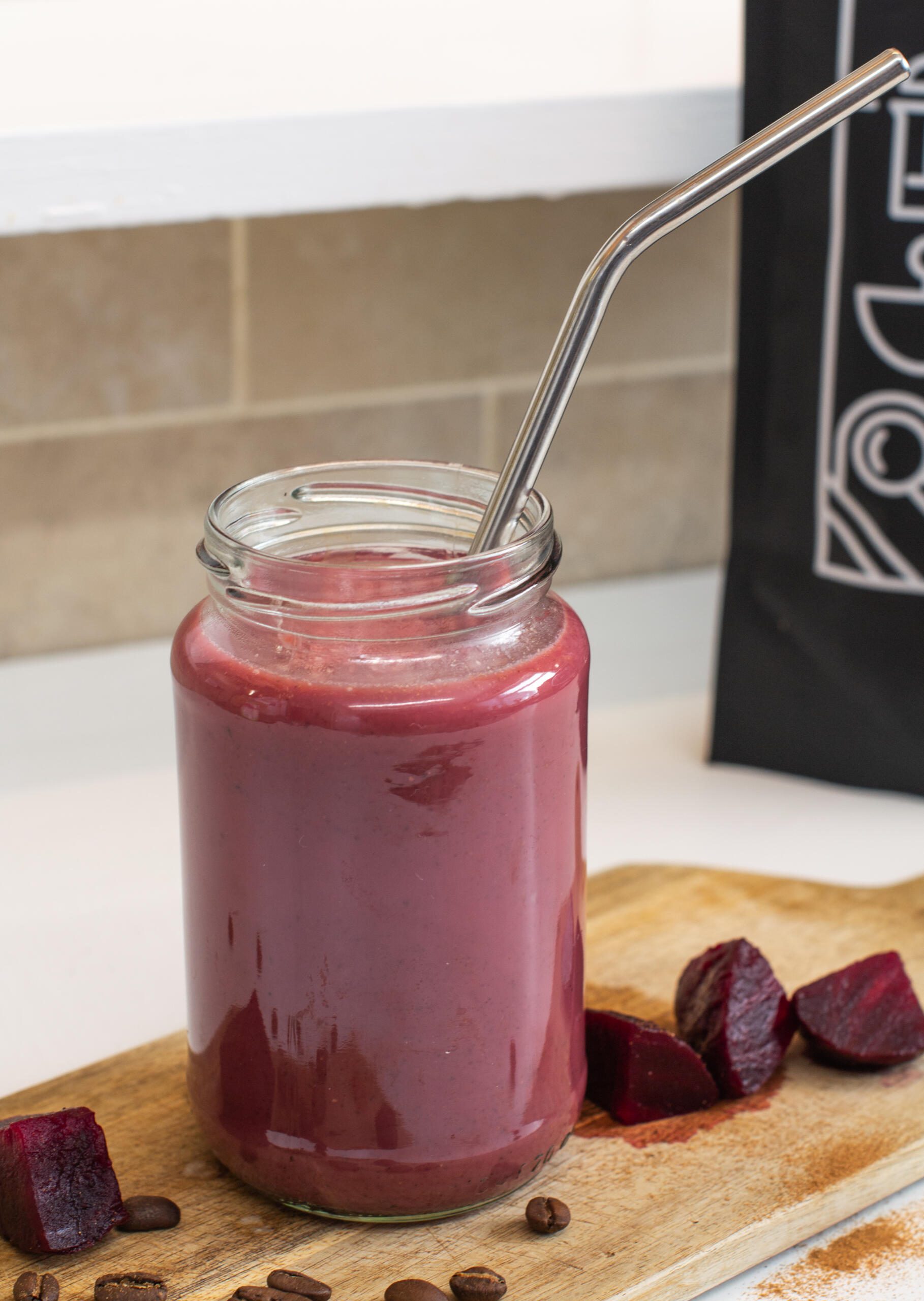 Spiced beetroot latte with metal straw 