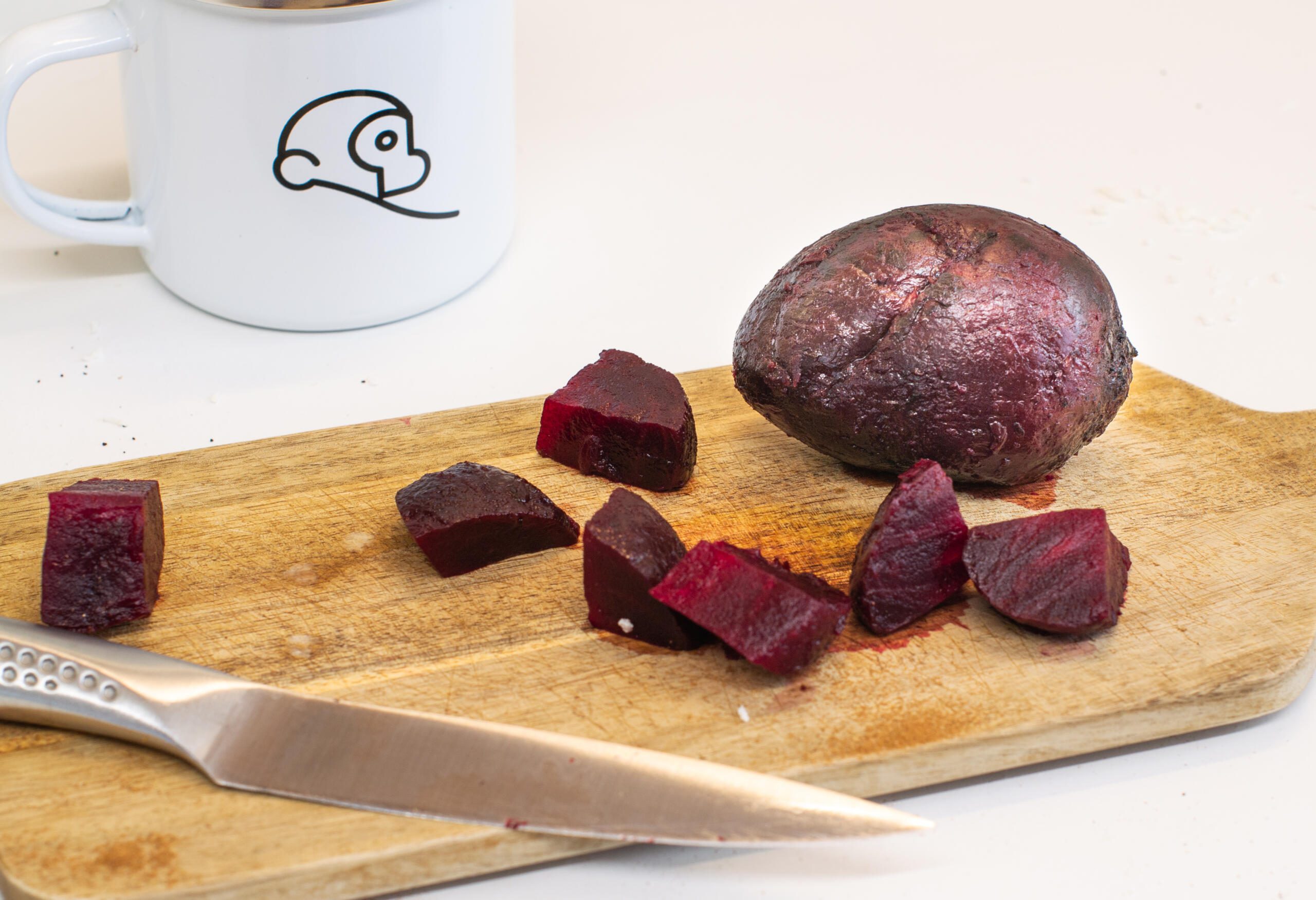 Chopped beetroot with knife and white Two Chimps Coffee mug 