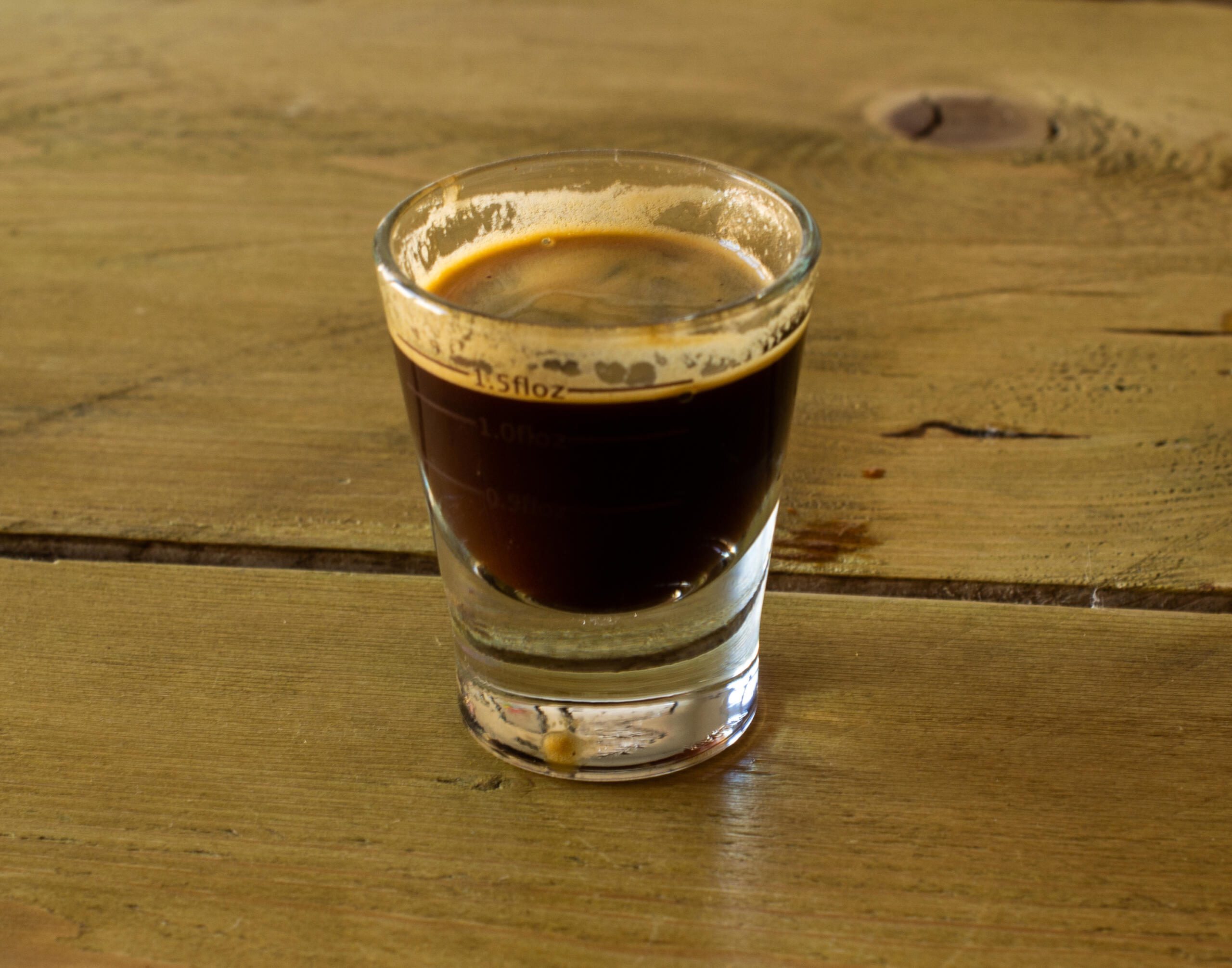 Espresso in a glass with a thin crema 