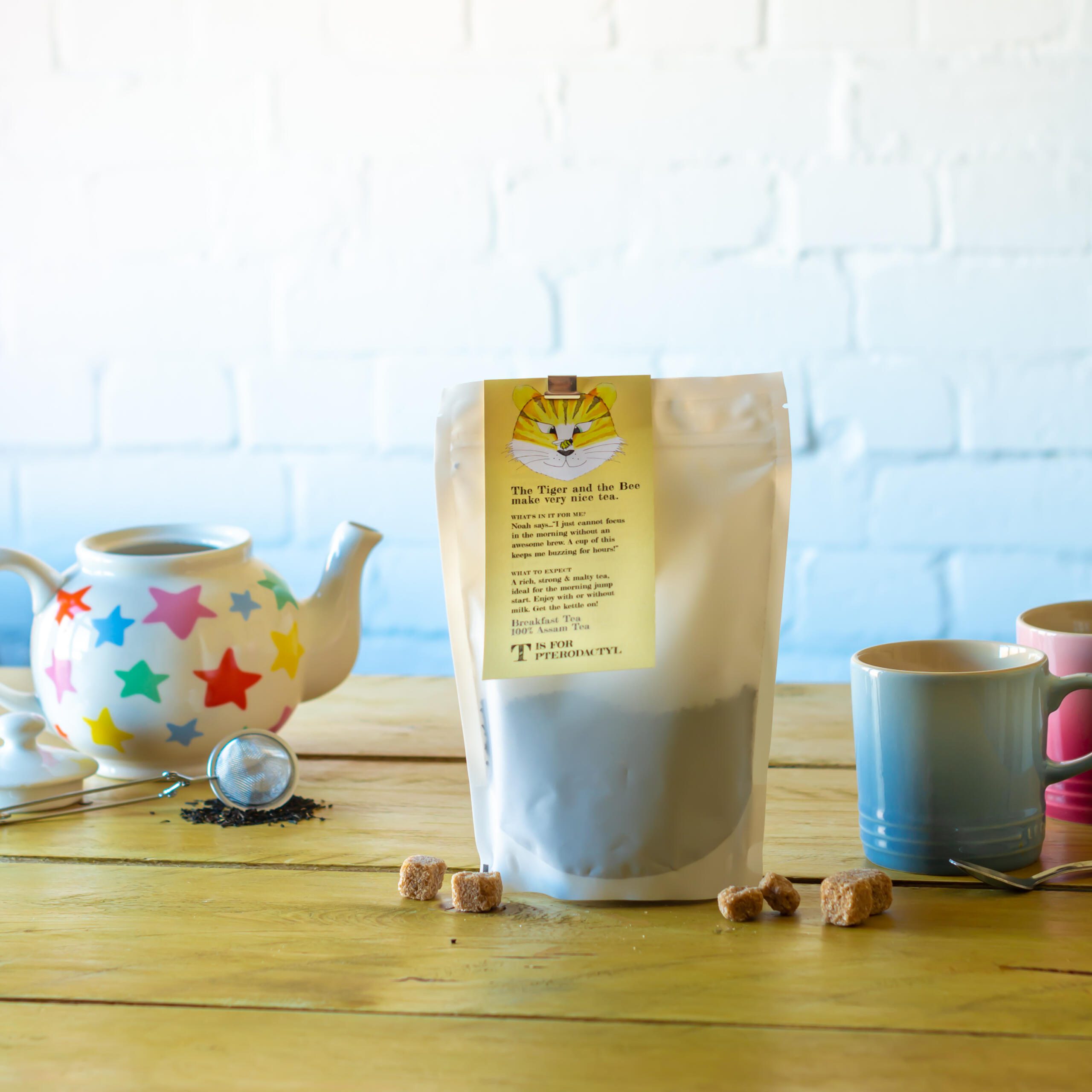 Two Chimps loose leaf english breakfast tea beside blue mug, teapot and sugar cubes 