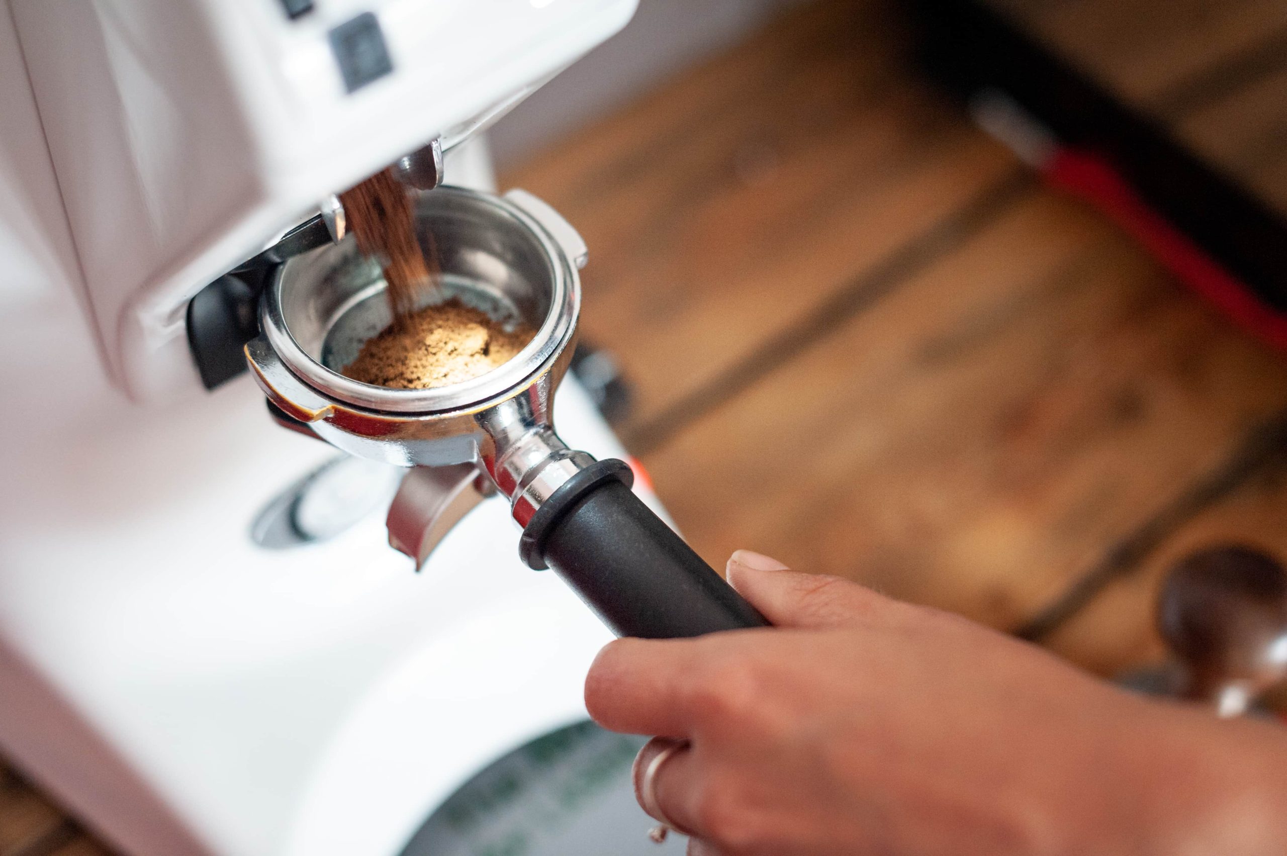 espresso coffee being ground into a portafilter