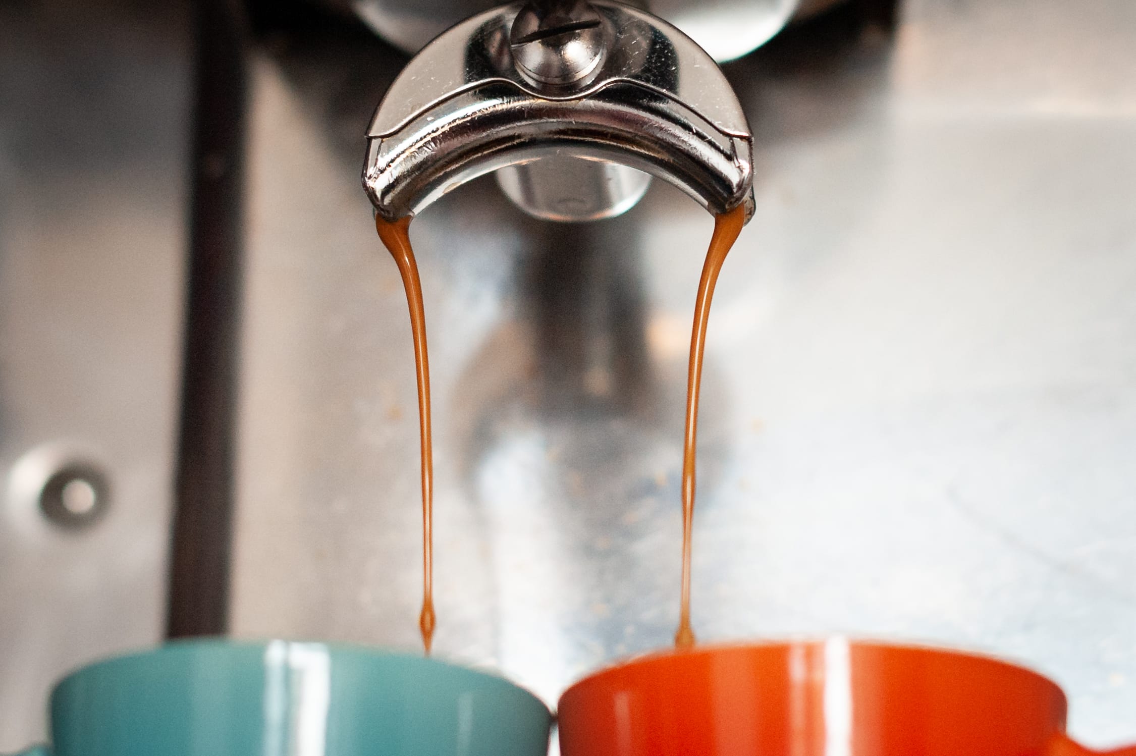 espresso pouring into two cups