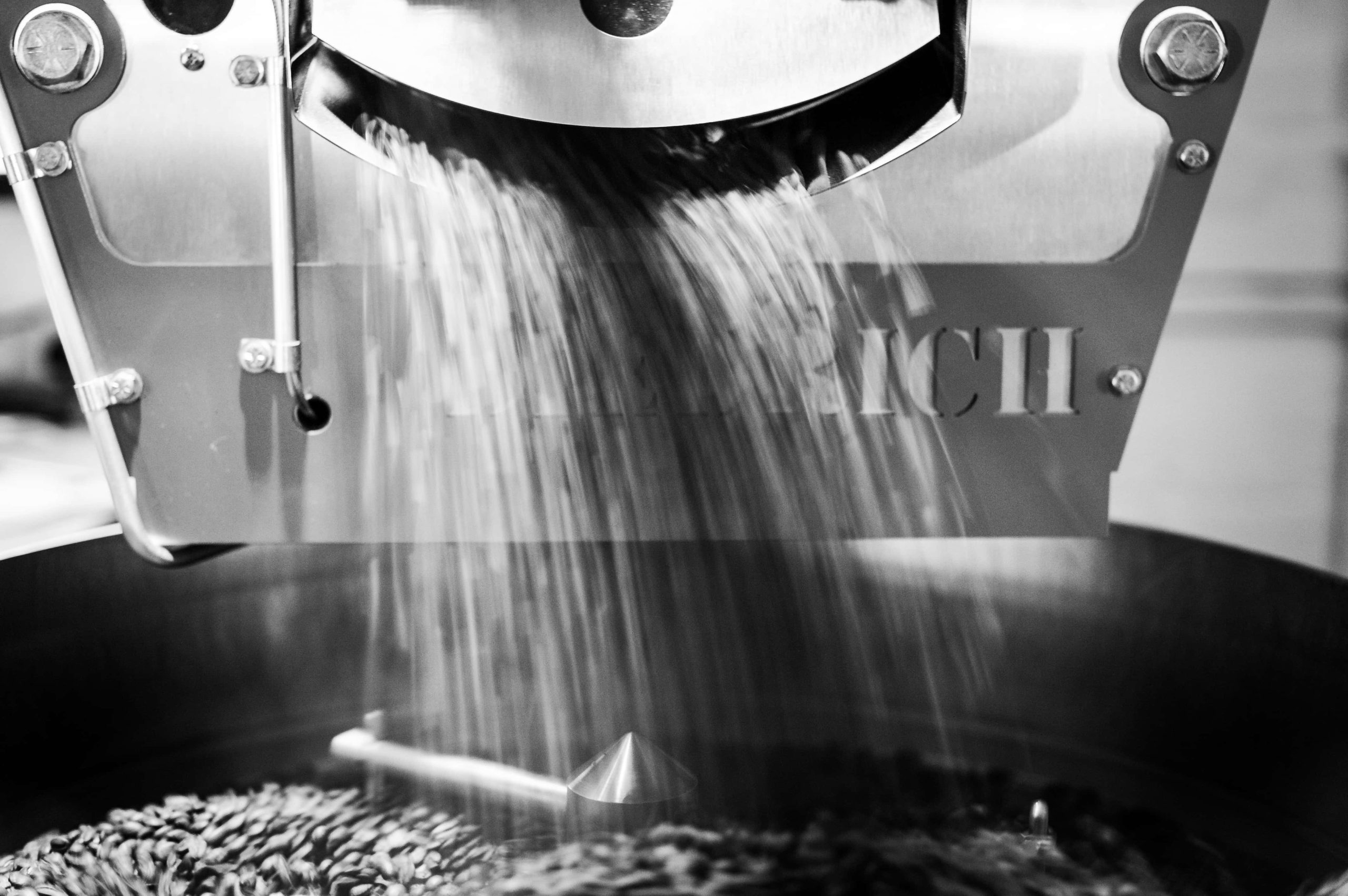 Coffee being poured from a roaster drum