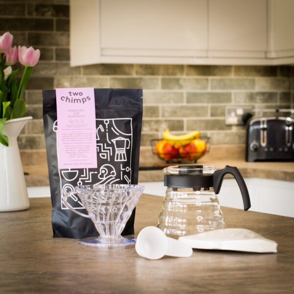 V60, jug, filters, scoop and coffee on kitchen worksurface