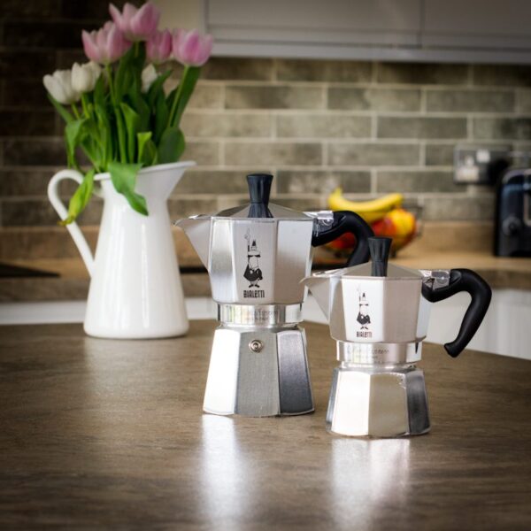 two unboxed bialetti express moka pots in different sizes on a kitchen worktop