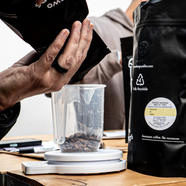 Guests at the create your own coffee blend course weighing coffee