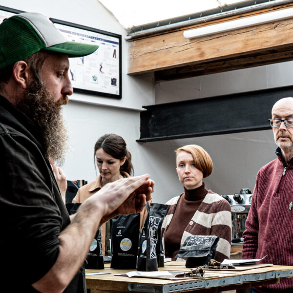 Guests at the create your own coffee blend course listening to Andy from Two Chimps