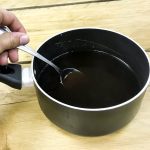 stirring espresso jelly in a saucepan