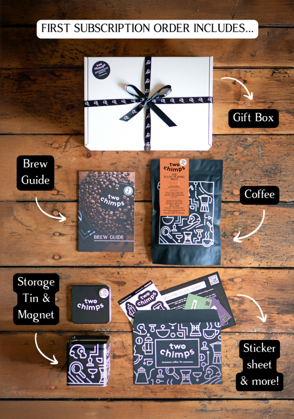 An image of the components of a Two Chimps specialty coffee subscription including medium-dark roasted coffee, tin and magnet and gift box