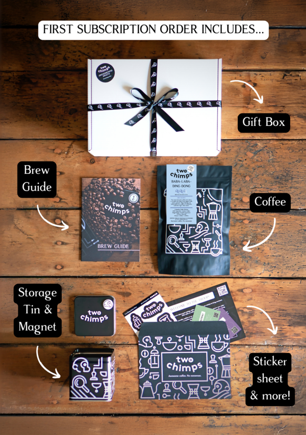 An image of the components of a Two Chimps specialty coffee subscription including medium-dark roasted coffee, tin and magnet and gift box