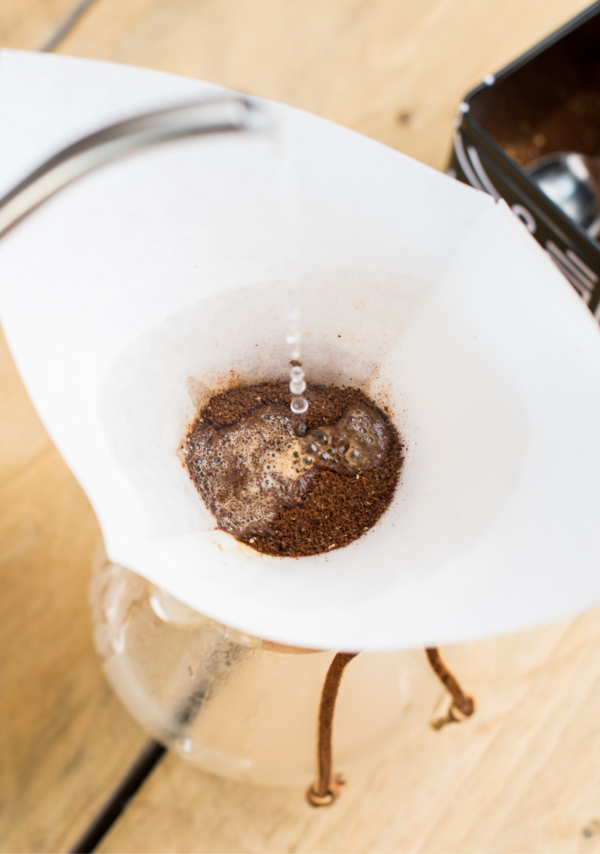 Water being poured into coffee grounds in chemex