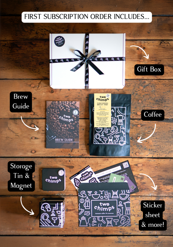 An image of the components of a Two Chimps specialty coffee subscription including light and fruity roasted coffee, tin and magnet and gift box