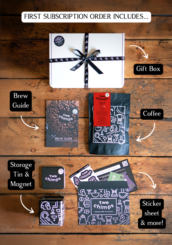 An image of the components of a Two Chimps specialty coffee subscription including medium roasted coffee, tin and magnet and gift box
