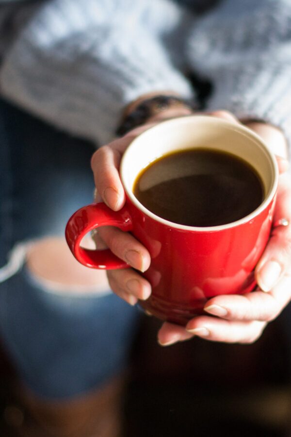 close up of red coffee cup in hand