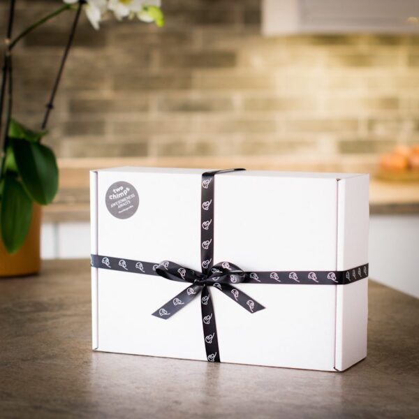 white ribbon tied gift box on kitchen worktop