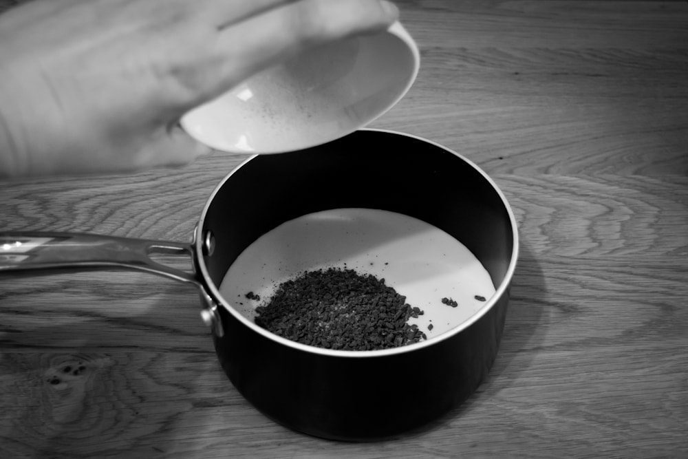 mint tea leaves in milk pan