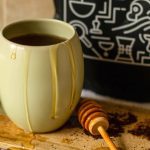 Honey dripping down coffee mug