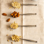 Four spoons with a selection of nuts