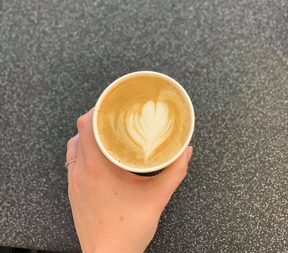 Overhead shot of hand holding a latte