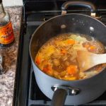 Coffee lamb stew beside Worcestershire sauce bottle and cafetiere