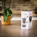 Hario Skerton Plus Coffee Grinder in front of packaging