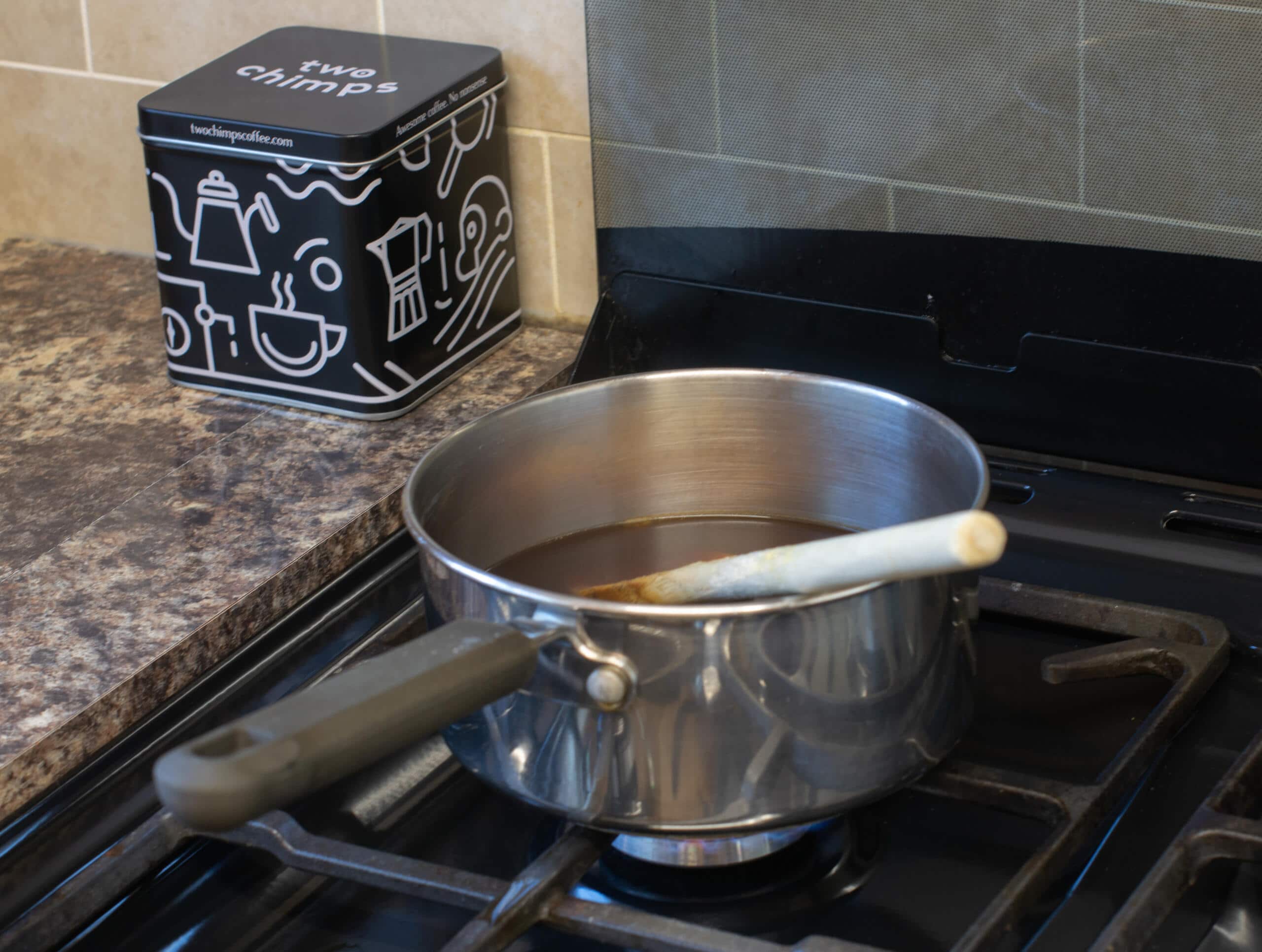 Coffee and sugar in saucepan sitting on hob