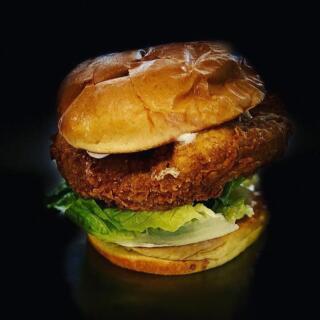 Vegan chicken burger on black background 
