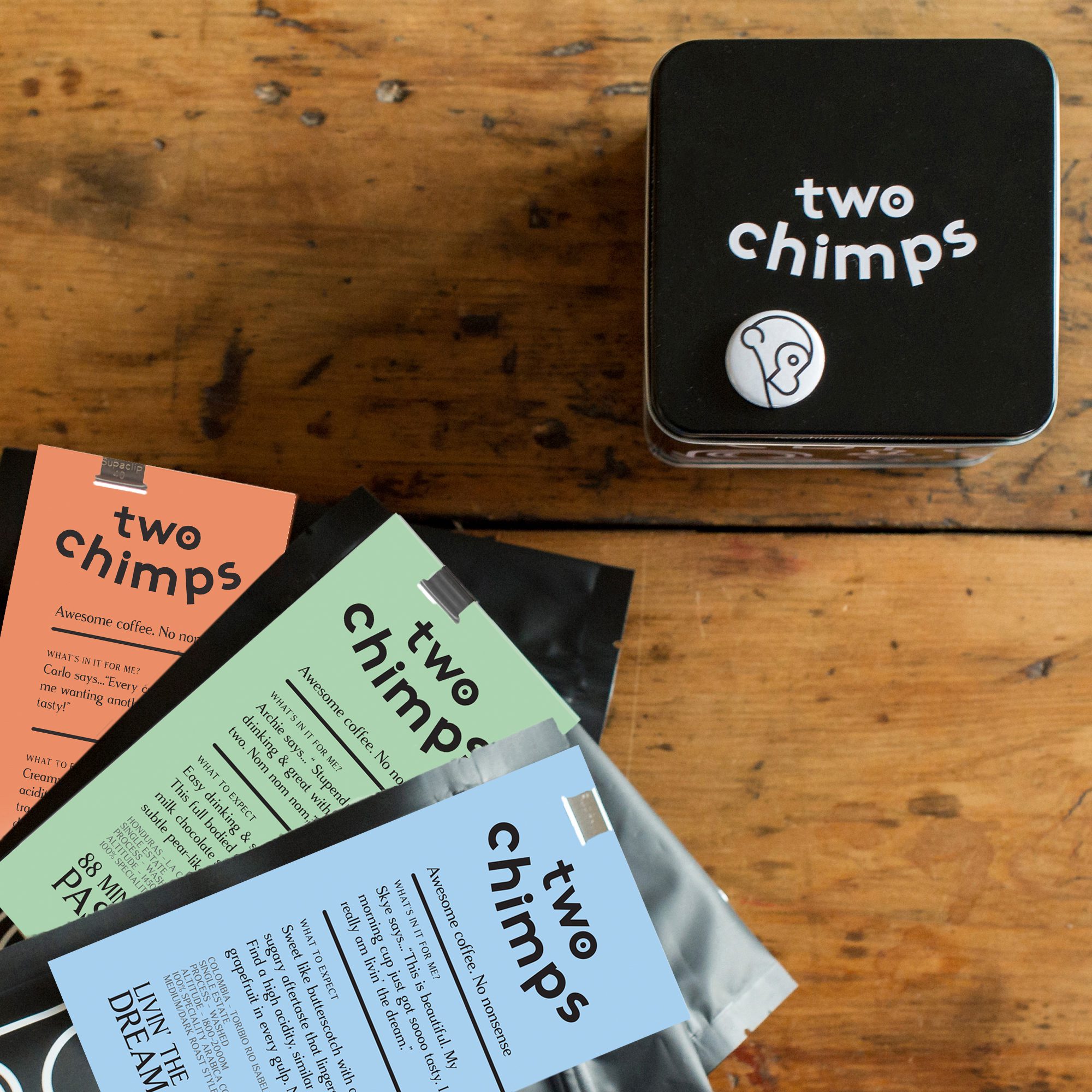 Two Chimps coffee tin and three bags of coffee with labels showing at an angle