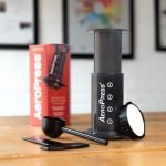 aeropress and box showing contents on a table