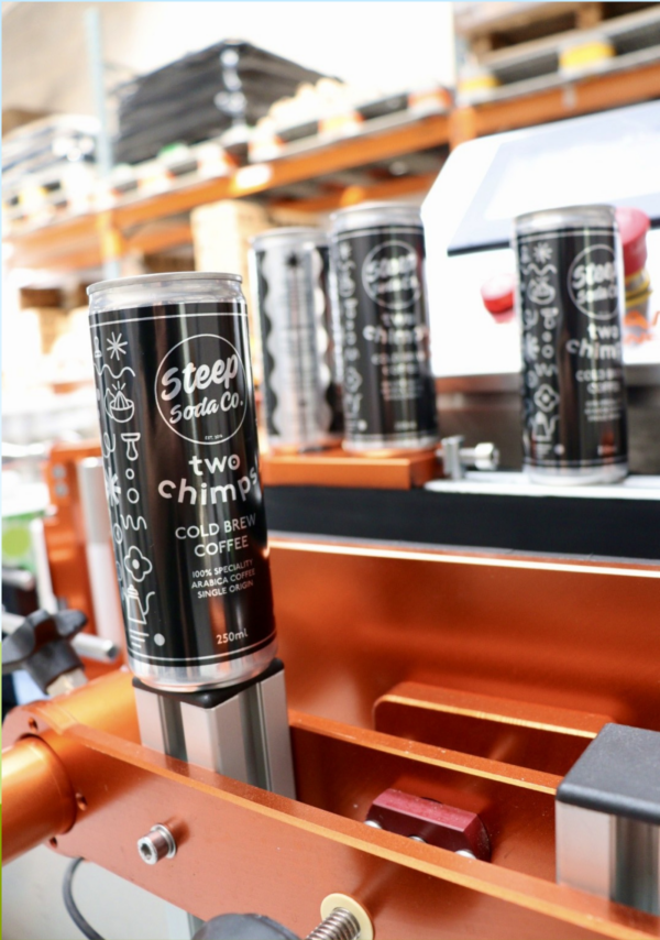 A can of Two Chimps Cold Brew coffee in the Steep Soda factory with label applied and can filled ready for distribution