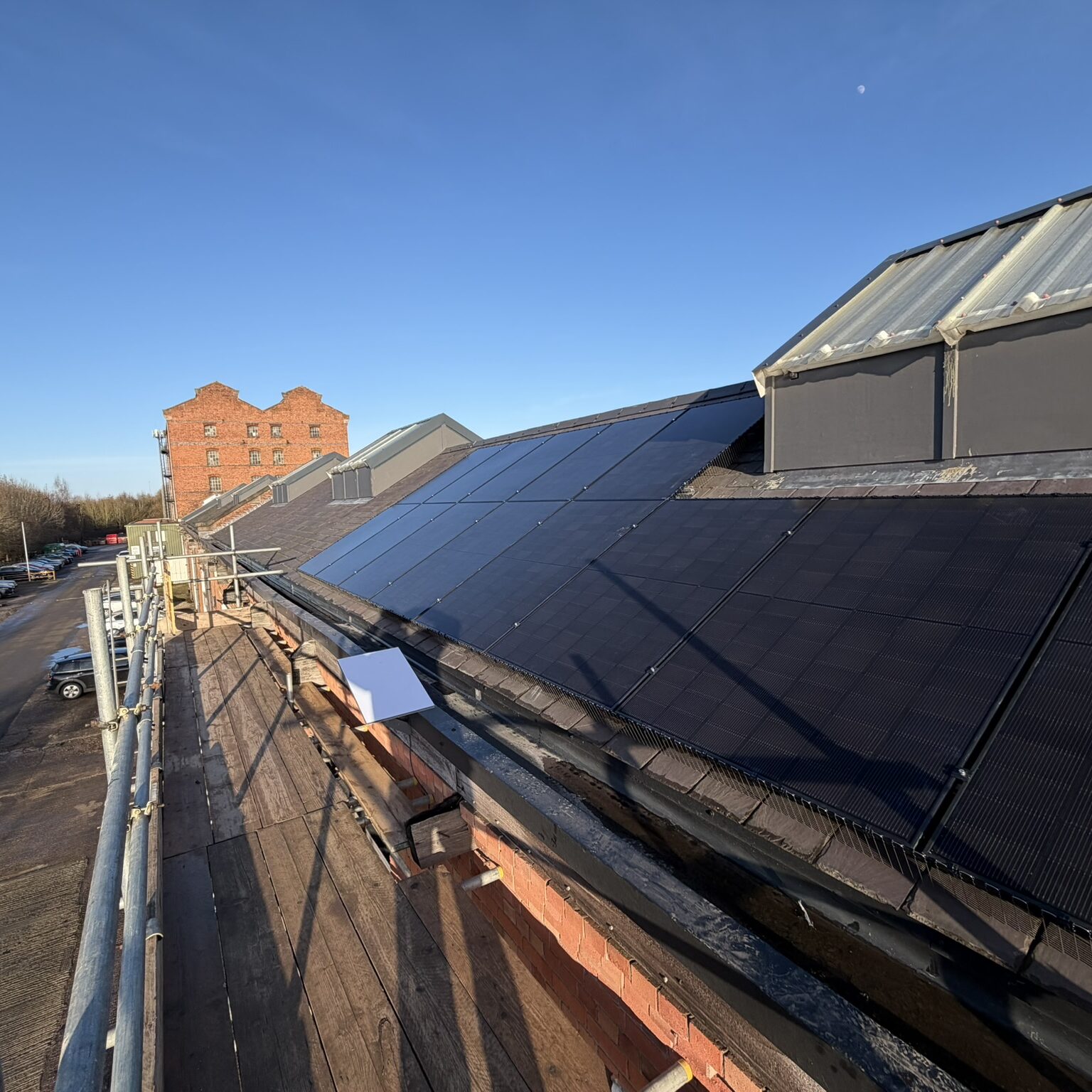 An aerial image of the solar panels on the roof of the Two Chimps roastery on a bright sunny day with clear blue skies