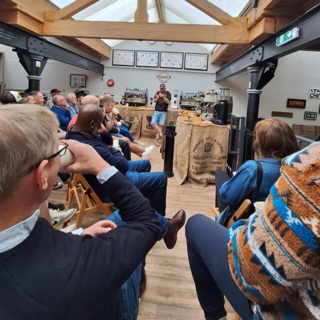 A wide angle photograph of a VIP barista event held at Two Chimps Coffee for subscribers. Showing Andy speaking